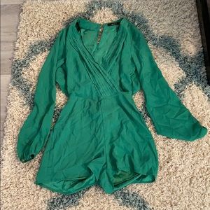 Green romper with open back and v neck